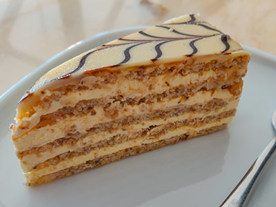 Esterhazy torte, one of the most recognizable Hungarian desserts in Budapest, as presented at August Cukraszda cake shop; walnut sponge cake with vanilla buttercream and white chocolate on top, photo by Ivan Kralj.
