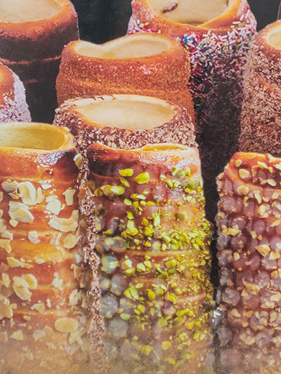 Kurtoskalacs or chimney cakes coated with variety of toppings (nuts, sugar, cinnamon...), as show on the image on one Fitzkey kiosk in Budapest, Hungary, photo by Ivan Kralj.