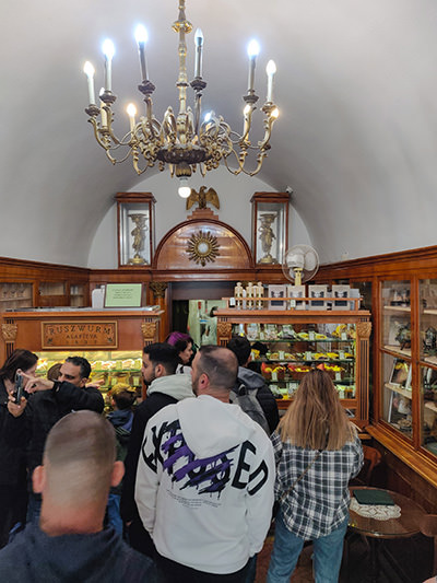 Ruszwurm Cukraszda pastry shop interior with antique furniture and many customers waiting in line for some of the best cakes in Budapest, Hungary, photo by Ivan Kralj.