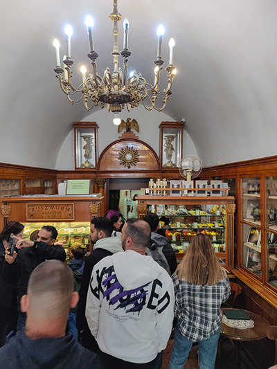 Ruszwurm Cukraszda pastry shop interior with antique furniture and many customers waiting in line for some of the best cakes in Budapest, Hungary, photo by Ivan Kralj.