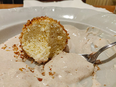 Turobomboc, half-eaten Hungarian cheese dumpling served in cinnamon-flavored sour cream, at Getto Gulyas restaurant, according to Pipeaway the best Hungarian dessert you can eat in Budapest, photo by Ivan Kralj.