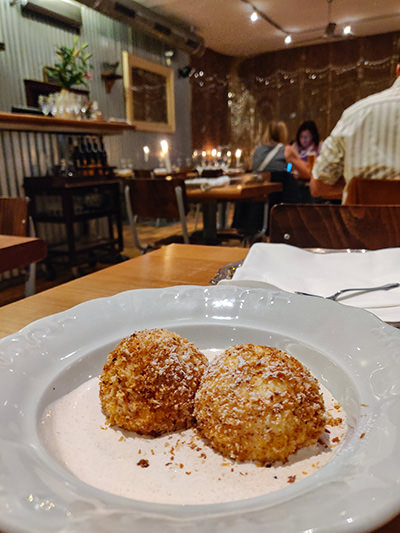 Turogomboc, two Hungarian cheese dumplings, the best Hungarian dessert in Budapest, served in cinnamon sour cream, at Getto Gulyas restaurant, photo by Ivan Kralj.