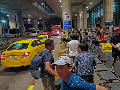Lines of people waiting for taxis at Manila airport in the Philippines; photo by Ivan Kralj.