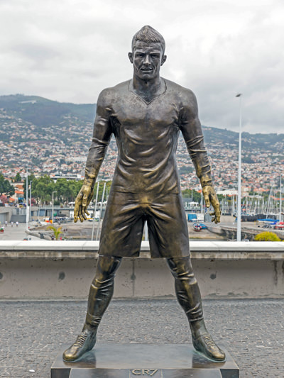 The bronze statue of Christiano Ronaldo in Funchal, Madeira, The footballer's shorts have changed color in the crotch area because of all the people rubbing it for good luck; photo by Wuestenigel.