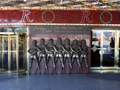 Statue of Crazy Girls, the back side of seven burlesque dancers with exposed butts in G-strings, a frequent rubbing spot in Las Vegas, for people hoping to get lucky in casinos, photo by Brx0.