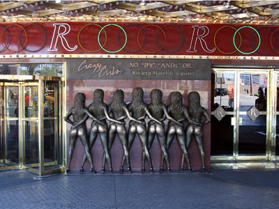 Statue of Crazy Girls, the back side of seven burlesque dancers with exposed butts in G-strings, a frequent rubbing spot in Las Vegas, for people hoping to get lucky in casinos, photo by Brx0.