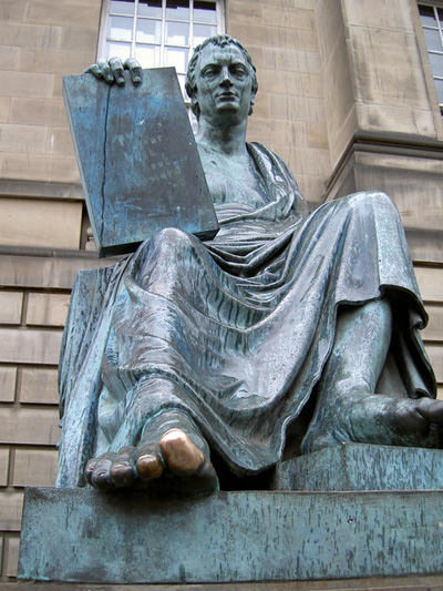 The golden toe on the bronze statue of David Hume in Edinburgh, Scotland, result of the frequent statue rubbing for good luck; photo by Neil Owen.