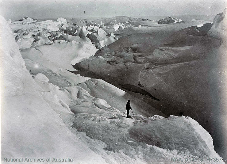 Man exploring Antarctica's icy landscape, shot during the British Antarctic Expedition 1907-1909.