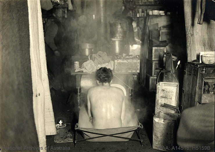 One of the men exploring Antarctica taking a bath in the cabin, shot behind his back, during the British Antarctic Expedition 1907-1909.