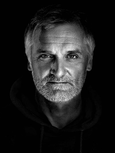 Black-and-white portrait of Slovenian photographer Matjaž Krivic; photo by Miran Juršič.