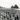 Rookery of hundreds of penguins with seals on the beach in Antarctica, shot during the BANZARE expedition 1929-1931.