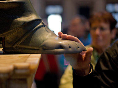 The lucky foot of Saint Peter's statue in Vatican, rubbed by the pilgrims looking for a blessing. Through the years, the foot lost its original shape; photo by Steven Mileham.