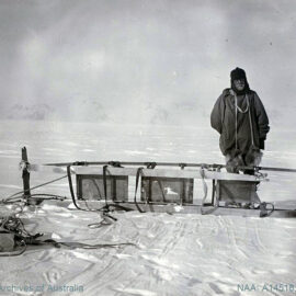 Sir Ernest Shackleton, Antarctic explorer, standing on the white continent by broken sledge, shot during the British Antarctic Expedition 1907-1909.
