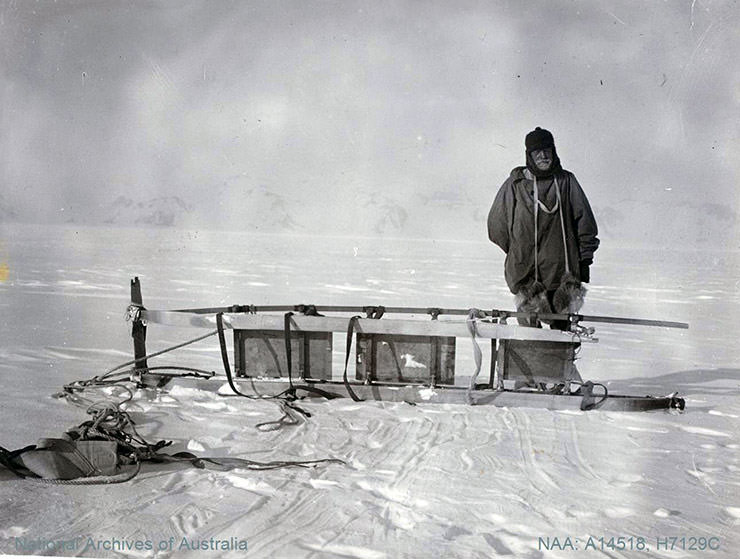 Sir Ernest Shackleton, Antarctic explorer, standing on the white continent by broken sledge, shot during the British Antarctic Expedition 1907-1909.