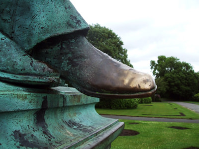 The golden tip of the shoe of the bronze statue of Sir Frances Powell. The color changed because of the constant rubbing by citizens of Wigan, UK; photo by Chris Skoyles.