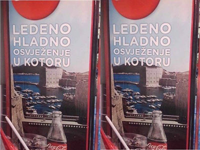Coca-Cola's marketing campaign in Kotor, Montenegro, promising "ice cold refreshment in Kotor" with an image of Dubrovnik, Croatia, in the background; photo by Dubrovnik.press.
