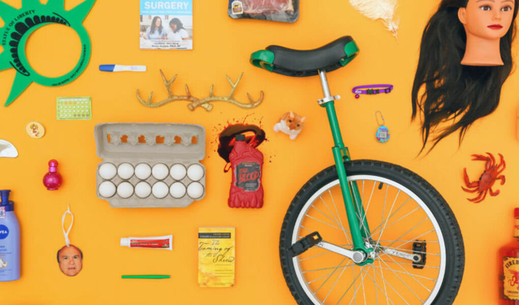 Display of a variety of items in Uber Lost and Found Index for 2023, from eggs and fake blood to unicycle and doll head.