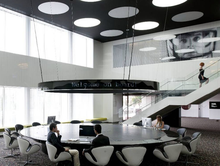 Gigantic round table in the interior of the hotel lobby at Barcelo Sants, space-themed hotel in Barcelona, Spain; photo by Booking.com.