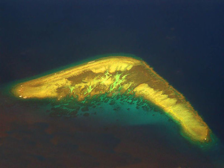 Petch Reef in the South China Sea, also known as the Boomerang Island, due to its shape; photo by Storm Crypt.