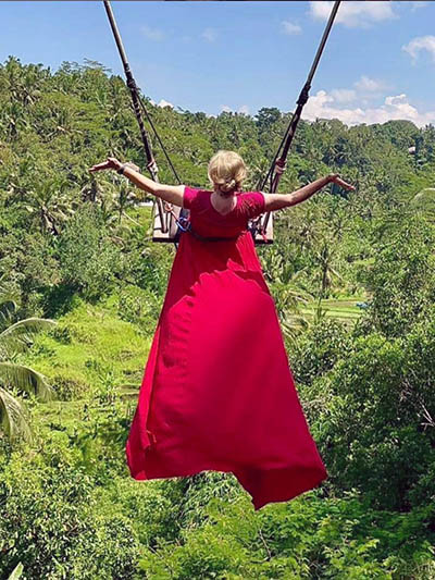 Ellie Hamby, an 81-year-old travel blogger known as a part of a TikTok Traveling Grannies duo, riding a giant swing in Bali, Indonesia.
