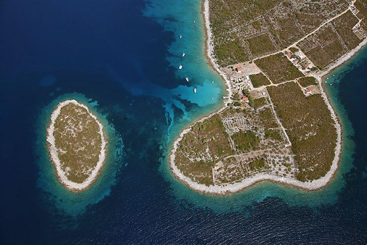 Merara island in Croatia that looks like a soccer ball about to be kicked by foot-shaped mainland peninsula; photo by Boris Kačan.