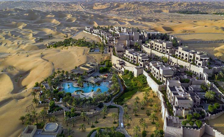 Luxury Qasr Al Sarab hotel by Anantara in Liwa Desert of the Empty Quarter in UAE, the largest uninterrupted sand desert in the world; photo by Booking.com.