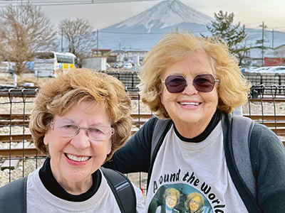 TikTok Traveling Grannies Sandy Hazelip and Ellie Hamby posing in front of Mount Fuji in Japan.