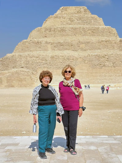 TikTok Traveling Grannies Sandy Hazelip and Ellie Hamby posing in front of a pyramid in Egypt.