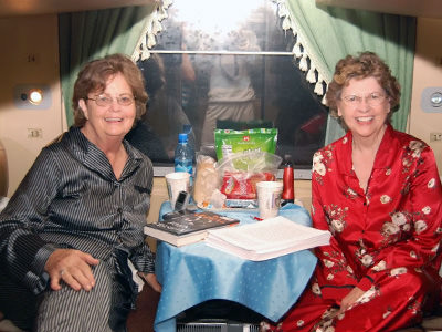 TikTok Traveling Grannies Ellie Hamby and Sandy Hazelip posing in their pyjamas in Tran-Siberian train.
