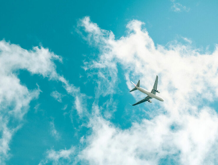 Frog's eye view of a plane flying below the skies; aviation industry is back in 2023, and these are the trends shaping its future; photo by Terra, Unsplash.