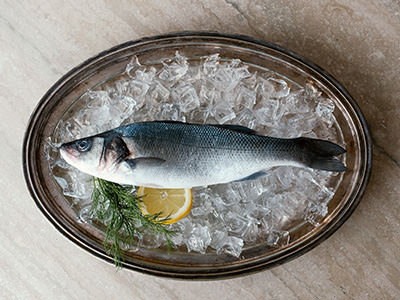 Raw fish displayed on ice with lemon and rosemary; an example of an unconventional room request by a hotel guest who brought the fish to the hotel; photo by Ryan Neeven, Hotels.com.