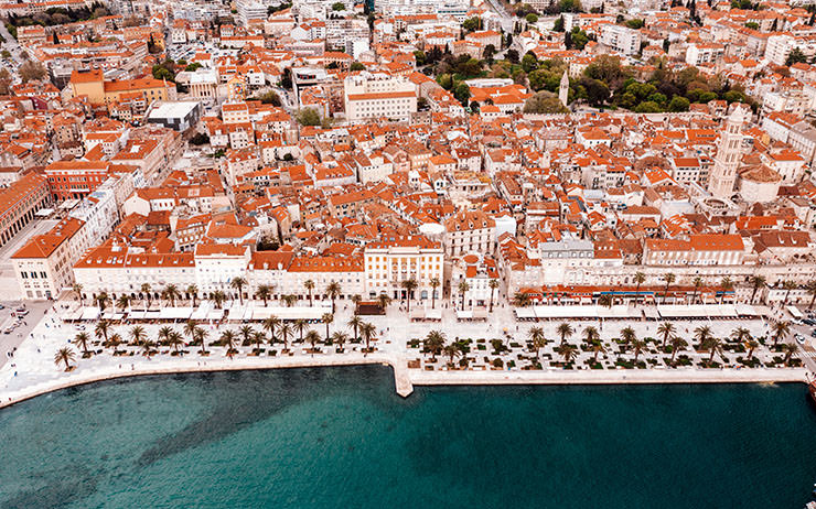Aerial view of Splitska Riva, the waterfront of Split, Croatia, a tourist destination struggling with overtourism and thus bringing new rules for tourists; photo by Spencer Davis, Unsplash.