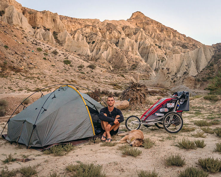 Tom Turcich, the world walker, camping in the wild with his dog Savannah.