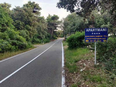 Roadsign for carpavle apartments on the road from Kampor to Suha Punta, where one should turn left on the way to free FKK Kandarola Beach on Rab island, Croatia; photo by Ivan Kralj.