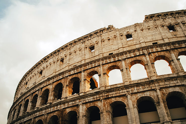 The exterior of the Colosseum, the famous amphitheater in Rome, Italy, a key spot in the European travel itinerary for first-time visitors; photo by Tony Litvyak, Unsplash.