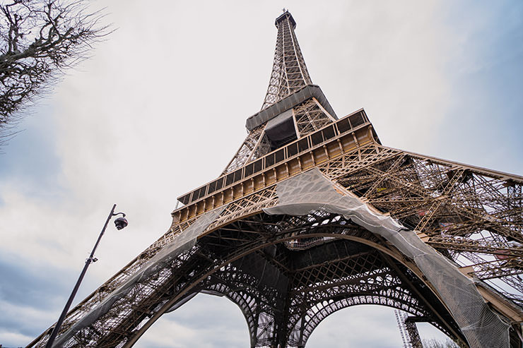 Eiffel Tower in Paris, France, viewed from the base, one of the recommended places to visit if you're traveling to Europe for the first time; photo by Eliška Doležalová, Unsplash.