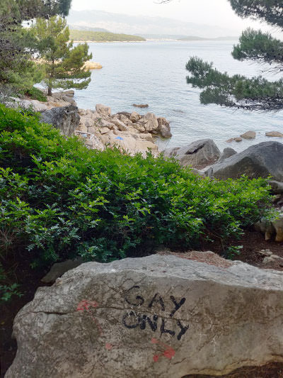 "Gay only" graffiti on a rock on FKK Kandarola peninsula, Rab, Croatia; photo by Ivan Kralj.
