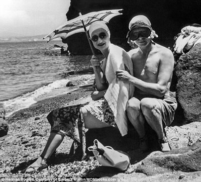 American socialite Wallis Simpson and English King Edward VIII posing for a photograph in beach swimwear during their Mediterranean cruise in 1936; copyright Herman Rogers, courtesy of Barbara Mason, Mombooks.com.