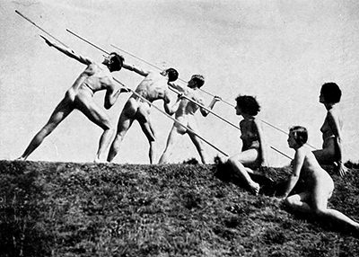 Naked young men throwing spears with naked young women watching, as a part of nacktkultur/FKK in Germany before the Second World War.