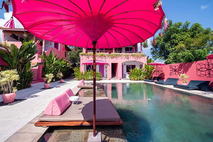 Pink-colored furniture by the swimming pool at PinkCoco Uluwatu hotel in Bali; photo by Pink Hotels.