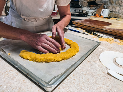 Baker Ružica Ribarić at Kuća rabske torte in Rab, Croatia, modeling a spiral filling for her cake; photo by Ivan Kralj. 