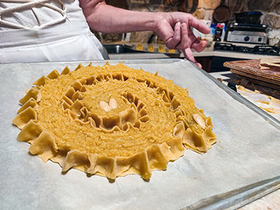 Rab cake made of almonds, citrus peels and maraschino cherry liqueur, prepared in a traditional spiral form and ready to be baked at Kuća rabske torte in Rab, Croatia; photo by Ivan Kralj.
