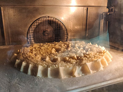 Rab cake being baked in the oven at Kuća rabske torte in Rab, Croatia; photo by Ivan Kralj.
