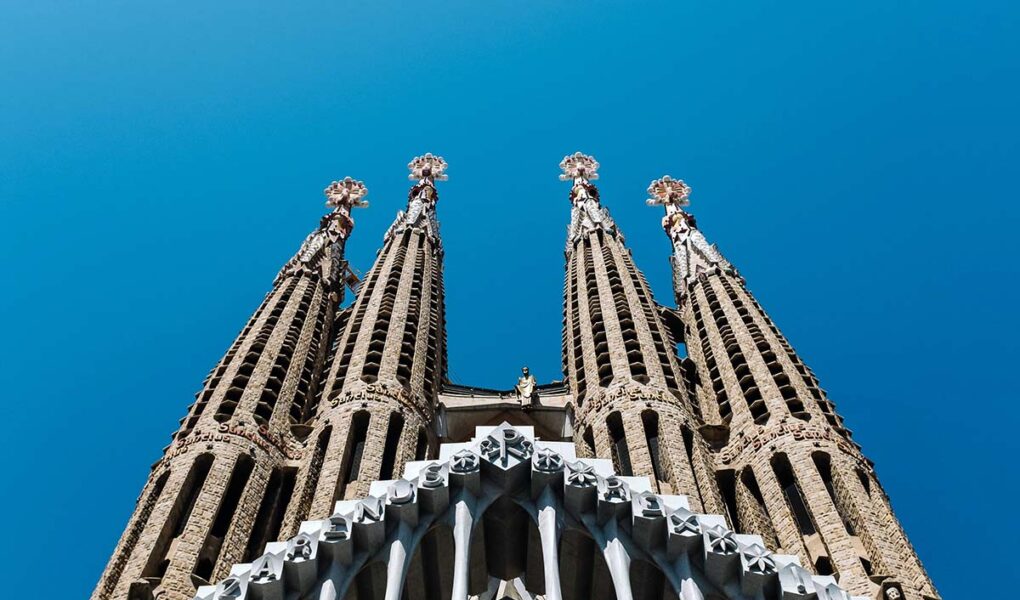 Towers of Antoni Gaudi's basilica Sagrada Familia in Barcelona, Spain, a must stop for the first European trip; photo by Ashim D'Silva, Unsplash.