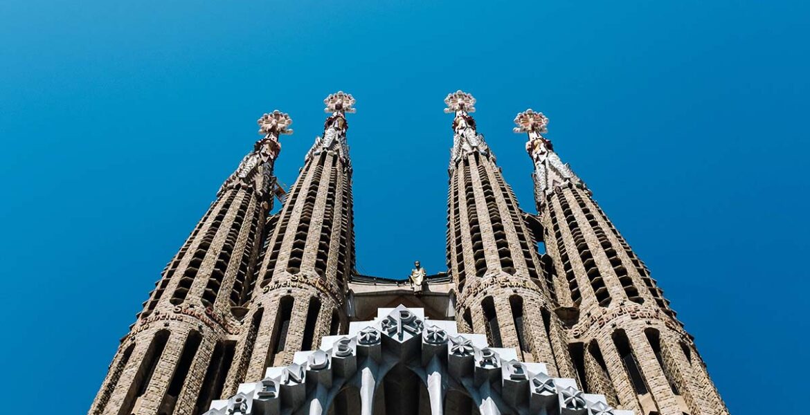 Towers of Antoni Gaudi's basilica Sagrada Familia in Barcelona, Spain, a must stop for the first European trip; photo by Ashim D'Silva, Unsplash.