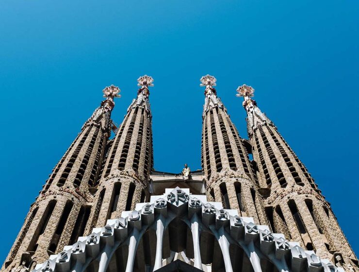 Towers of Antoni Gaudi's basilica Sagrada Familia in Barcelona, Spain, a must stop for the first European trip; photo by Ashim D'Silva, Unsplash.