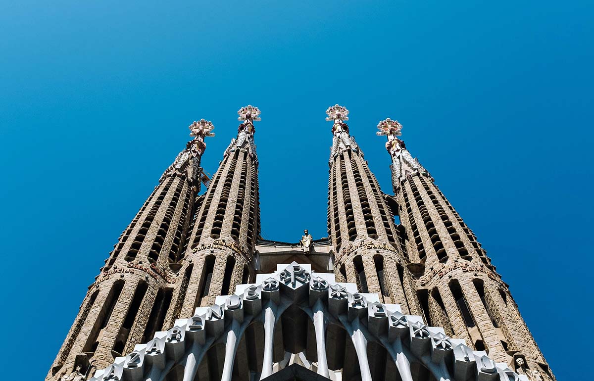 Towers of Antoni Gaudi's basilica Sagrada Familia in Barcelona, Spain, a must stop for the first European trip; photo by Ashim D'Silva, Unsplash.