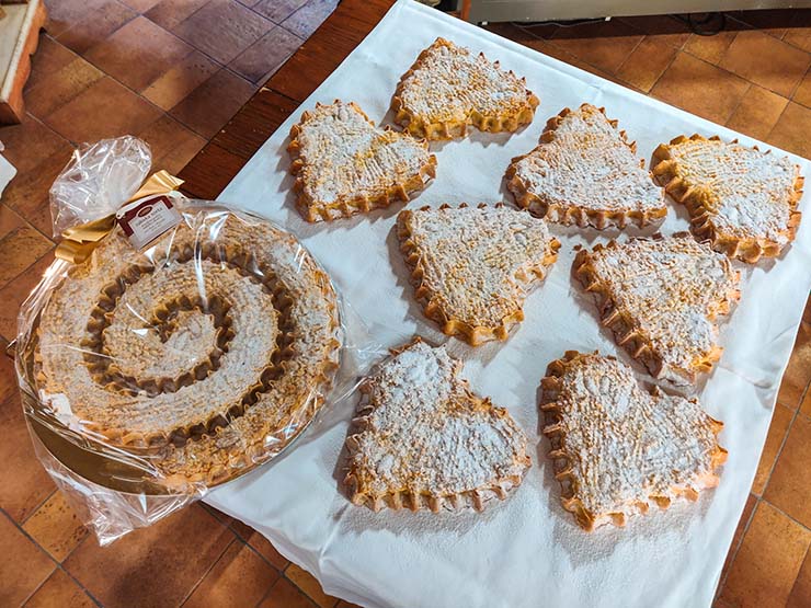 Rapska torta at Kuća rabske torte in Rab, Croatia, displayed in the traditional shape of snail shell, and more modern heart-shaped cakes; photo by Ivan Kralj.