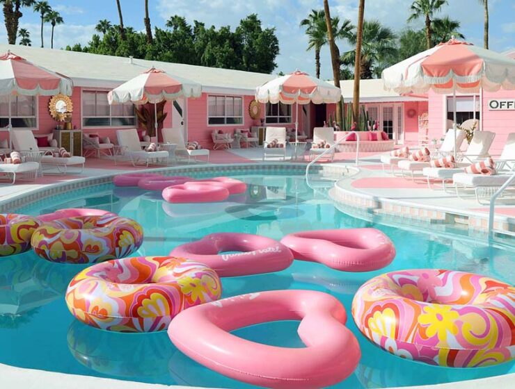 Trixie Motel swimming pool with pink floats, Barbie hotel style, in Palm Springs, California, USA.