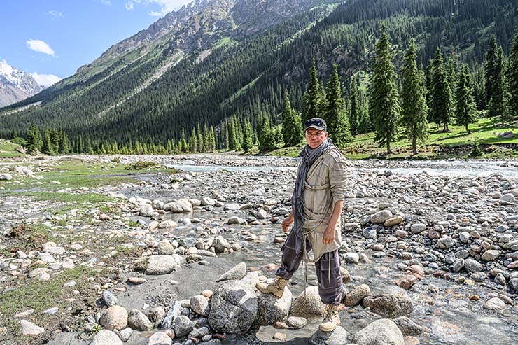 Alexey Gubarev, IT entrepreneur from Cyprus and MadWay Rally organizer, standing in the nature of Kyrgyzstan.